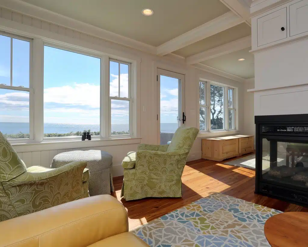 Charming Cottage living room with windows overlooking the water