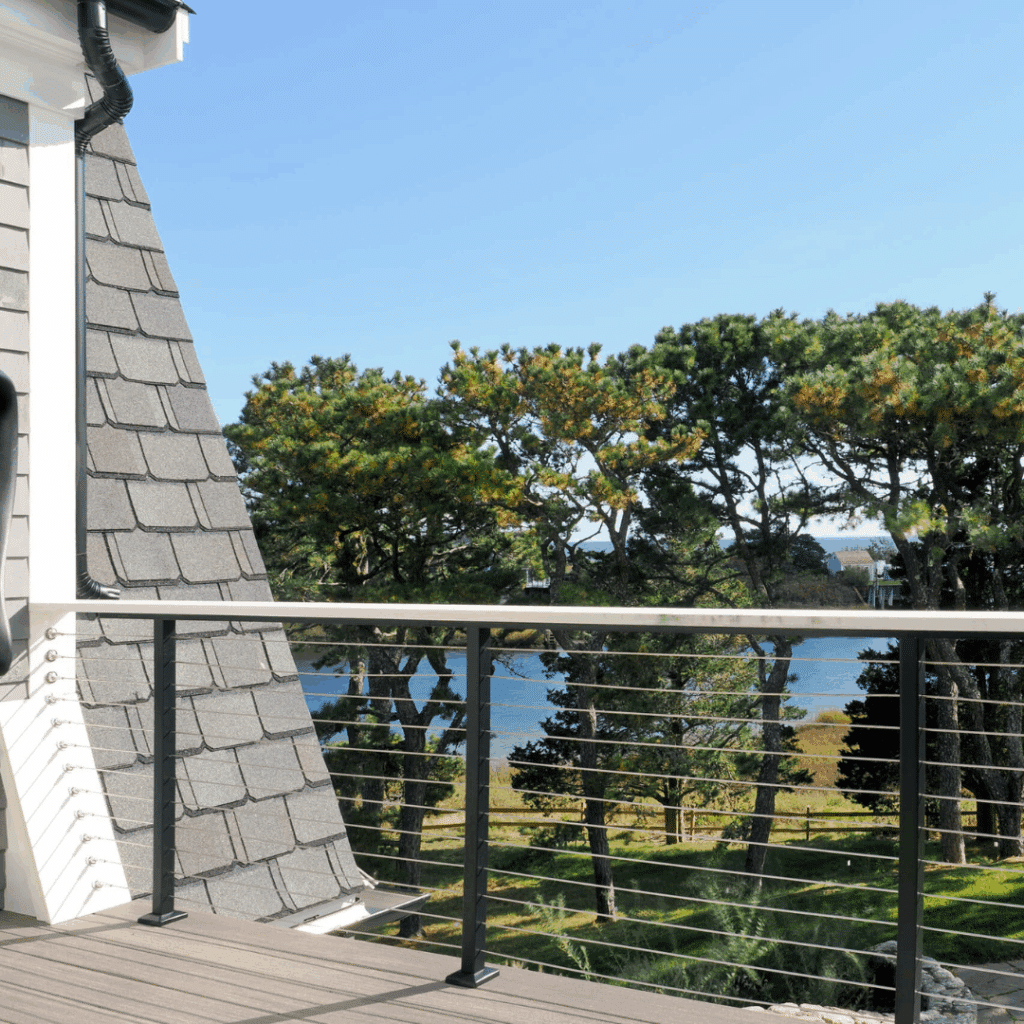 Indoor to outdoor living space in a Cape Cod home with deck overlooking coastal landscape